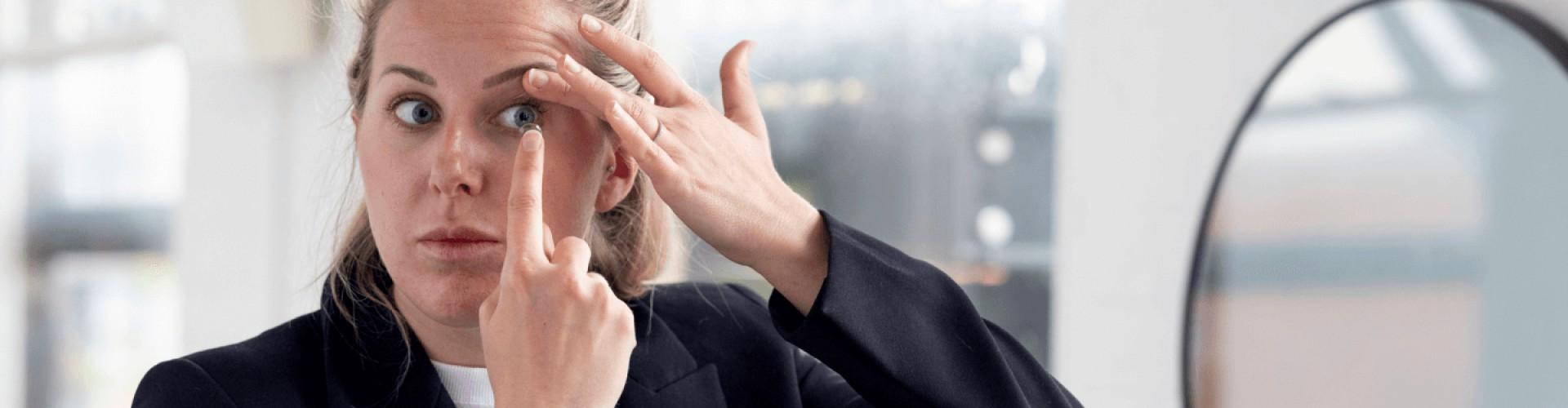 Woman putting in a contact lens