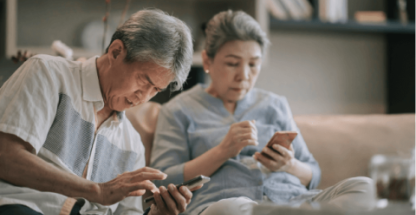 Elderly couple looking for information on their phone