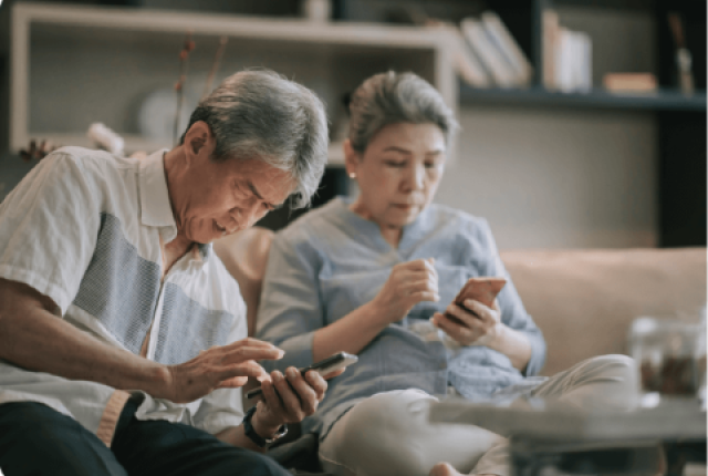 Elderly couple looking for information on their phone